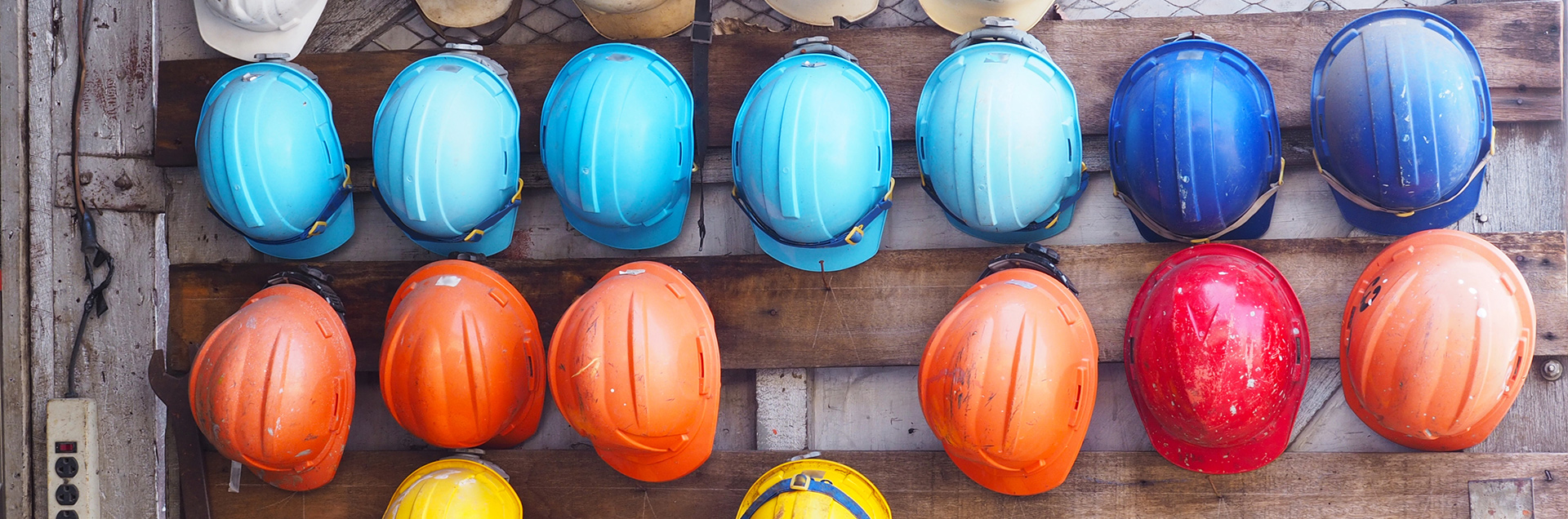 Array of hardhats representing construction workers